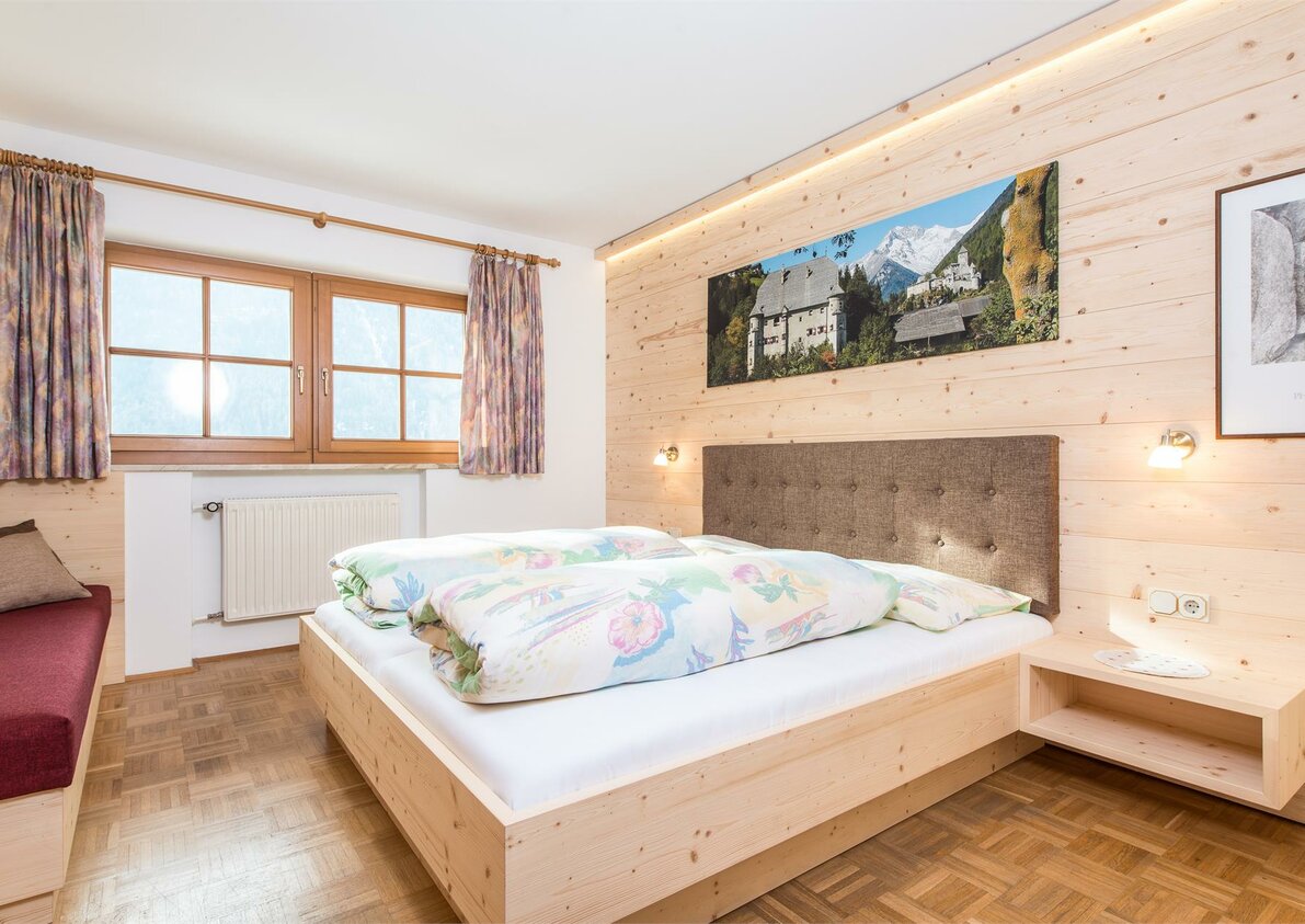 Sonnenparadies bedroom with three beds in naturale wood